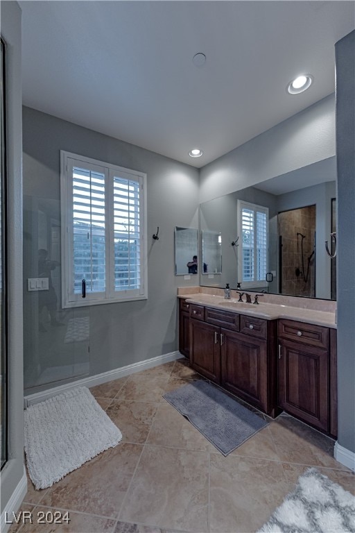 bathroom featuring walk in shower, vanity, and tile patterned floors