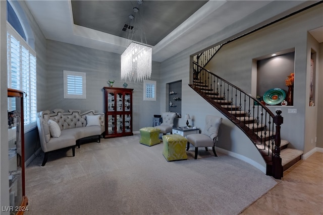 living area with an inviting chandelier and carpet