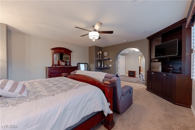 bedroom with ceiling fan and light carpet