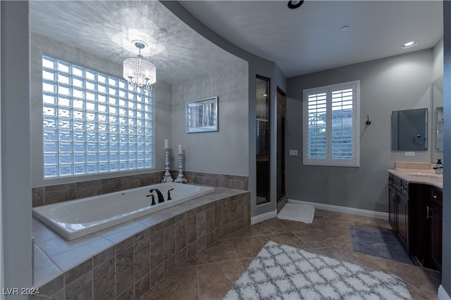 bathroom with vanity, plus walk in shower, a chandelier, and tile patterned floors