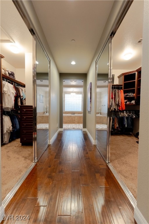 corridor with hardwood / wood-style flooring