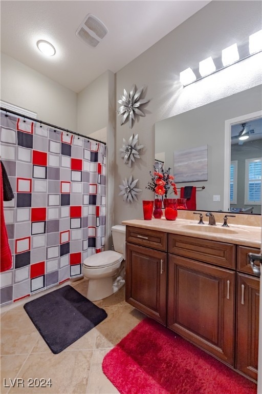 bathroom with vanity, toilet, and tile patterned floors