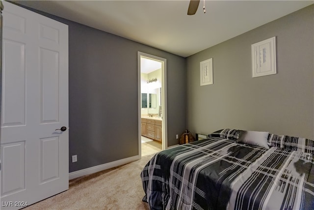 carpeted bedroom with ceiling fan and connected bathroom