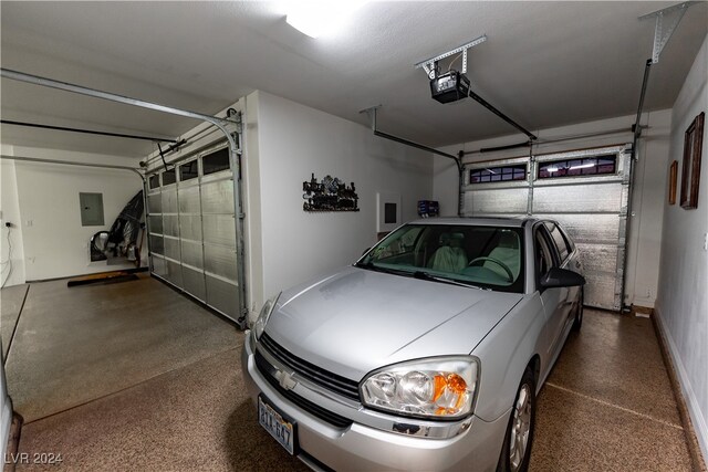 garage with a garage door opener and electric panel