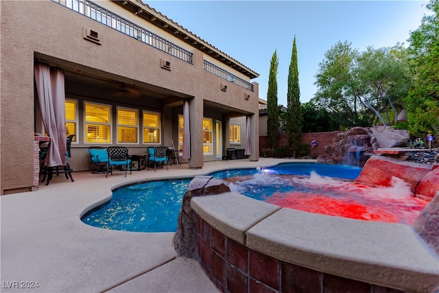 view of pool with a patio and pool water feature