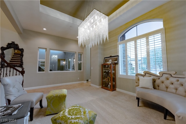 living area featuring a notable chandelier, light colored carpet, and plenty of natural light