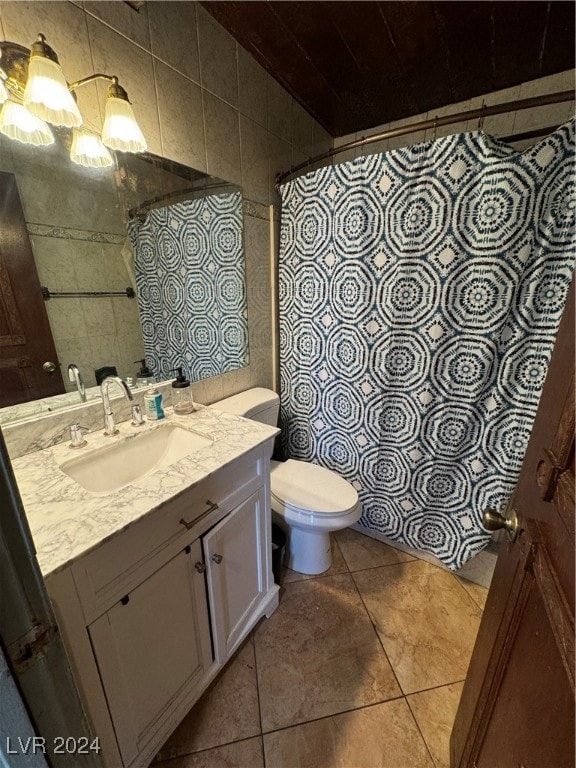 bathroom featuring vanity, toilet, walk in shower, tile walls, and tile patterned flooring