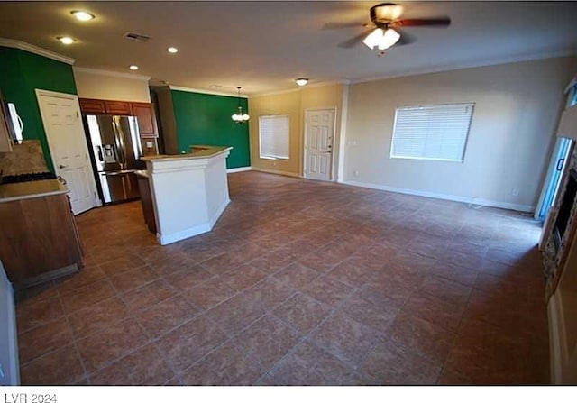 kitchen with crown molding, ceiling fan with notable chandelier, pendant lighting, and stainless steel refrigerator with ice dispenser