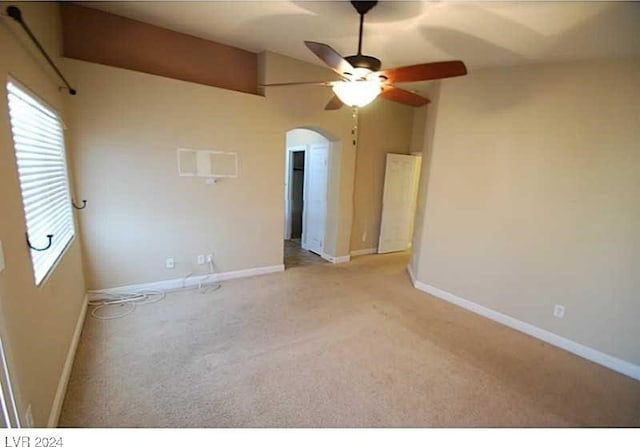 spare room featuring ceiling fan and light colored carpet