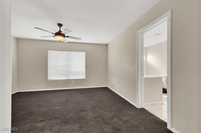 spare room featuring carpet floors, baseboards, and ceiling fan