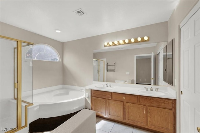 bathroom with a shower stall, a garden tub, a sink, and visible vents