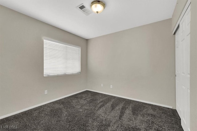 carpeted empty room with visible vents and baseboards