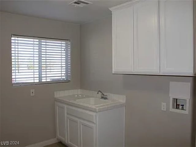 laundry area featuring hookup for a washing machine, sink, and cabinets