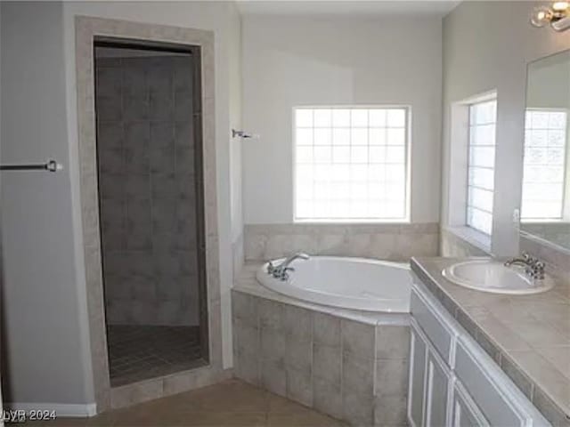 bathroom featuring vanity, shower with separate bathtub, and tile patterned flooring