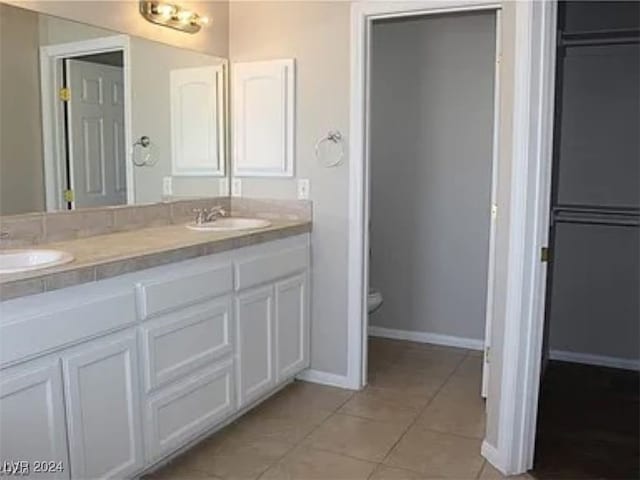 bathroom featuring tile patterned flooring, vanity, and toilet