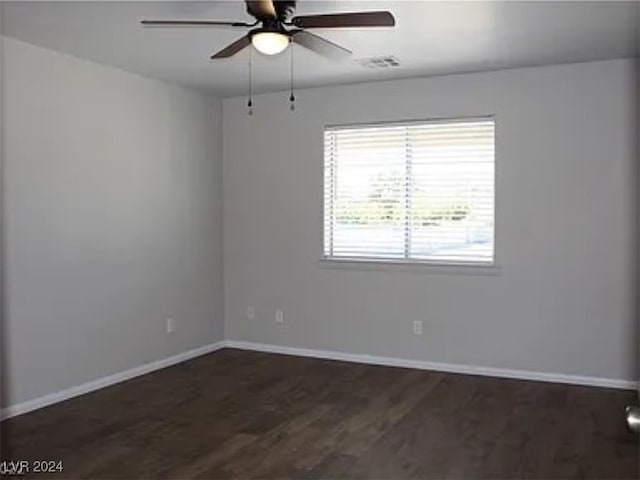 unfurnished room with ceiling fan and dark wood-type flooring