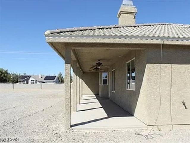 exterior space featuring ceiling fan