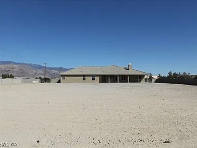 back of property with a mountain view