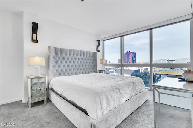 4471 Dean Martin Dr Unit 606, Las Vegas, NV 89103 - carpeted bedroom featuring a city view and expansive windows