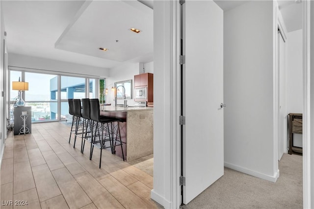 4471 Dean Martin Dr Unit 606, Las Vegas, NV 89103 - kitchen with a breakfast bar, stainless steel microwave, and a peninsula