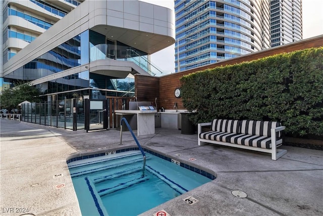 4471 Dean Martin Dr Unit 606, Las Vegas, NV 89103 - view of pool featuring exterior kitchen, a patio area, a pool, and an outdoor hangout area