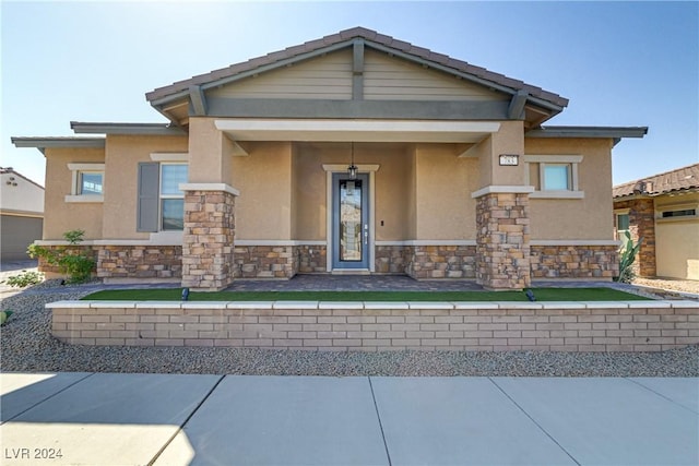 view of front of house featuring stone siding and stucco siding