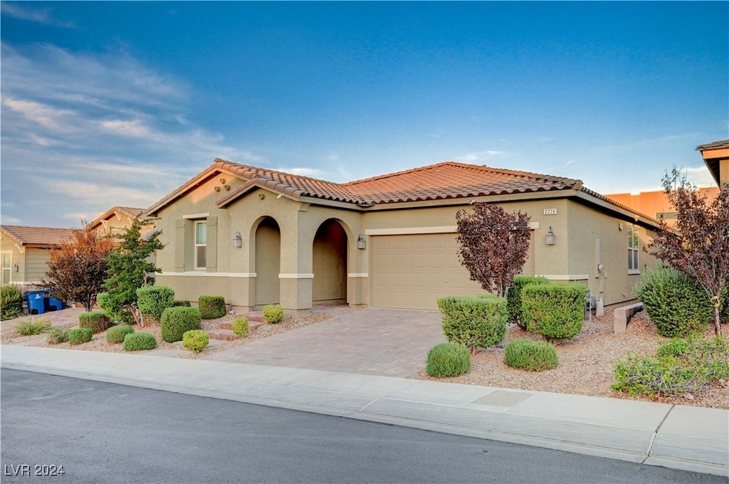 mediterranean / spanish-style home with a garage