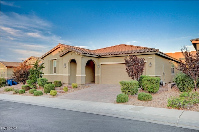 mediterranean / spanish-style home with a garage