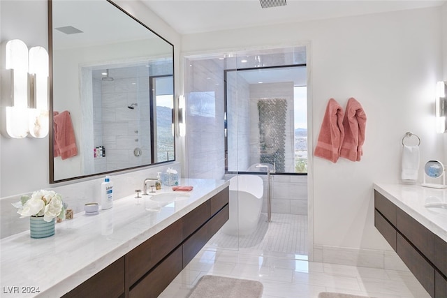 bathroom featuring vanity, separate shower and tub, and tile patterned floors