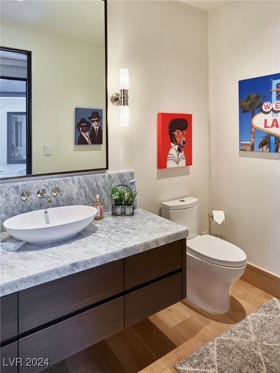 bathroom with vanity, hardwood / wood-style floors, and toilet