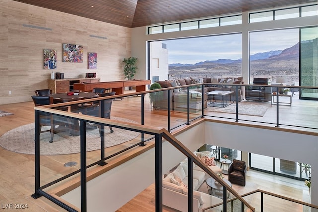 stairway with wooden ceiling, a mountain view, and hardwood / wood-style flooring