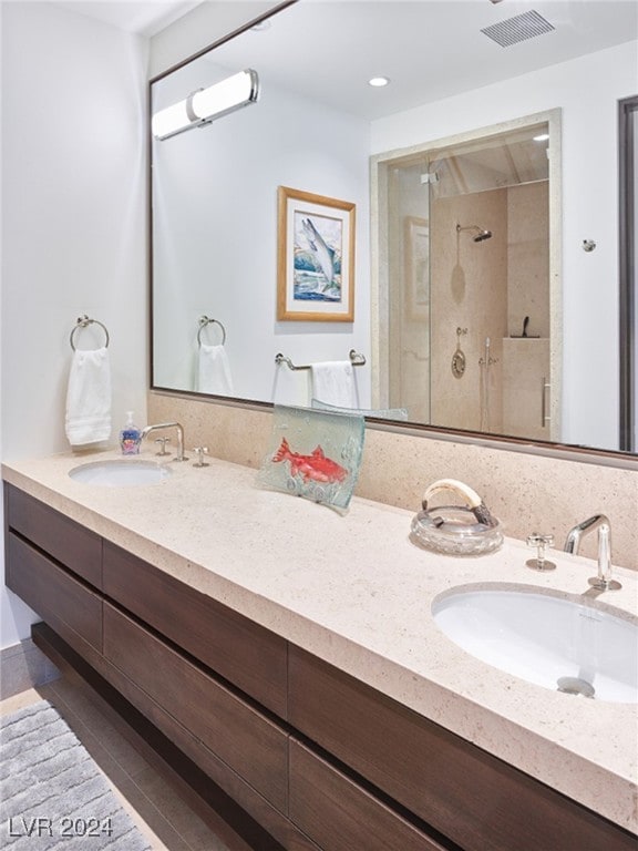 bathroom with tile patterned flooring, an enclosed shower, and vanity