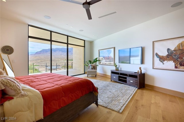 4915 Summit Overlook Dr, Las Vegas, NV 89135 - bedroom with access to outside, light wood finished floors, baseboards, and a ceiling fan
