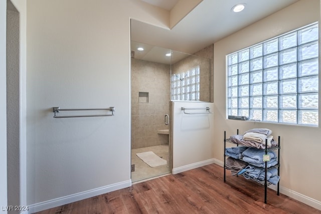 bathroom with hardwood / wood-style floors and a shower with door