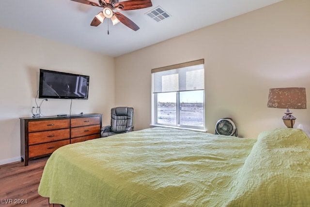 bedroom featuring ceiling fan and dark wood-type flooring