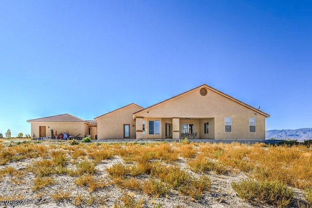 rear view of property with a mountain view