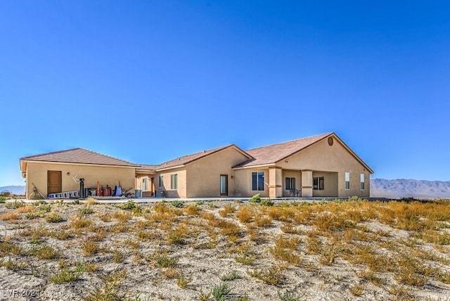 rear view of property featuring a mountain view