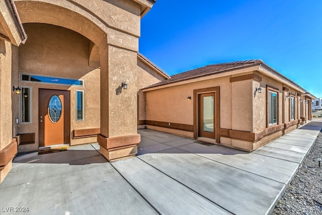 property entrance featuring a patio area