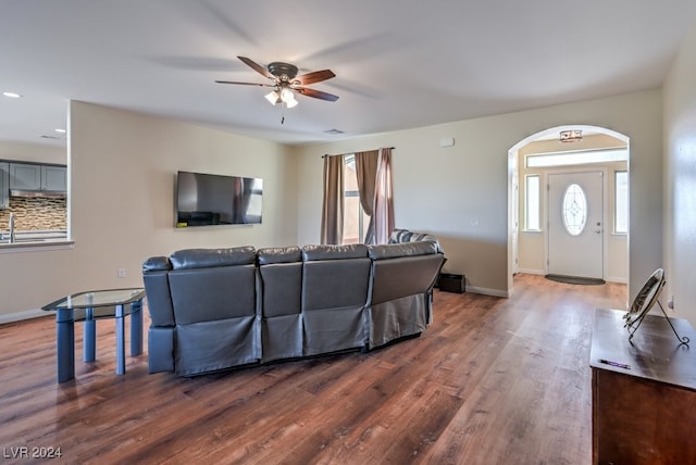 living room featuring dark hardwood / wood-style floors and ceiling fan