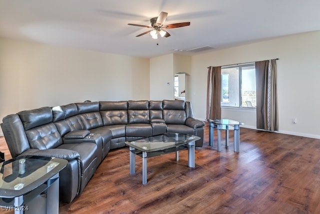 living room featuring ceiling fan and dark wood-type flooring