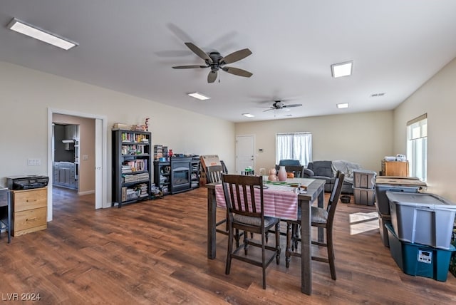 dining space with ceiling fan and dark wood-type flooring