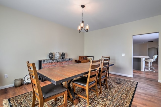 dining space with a chandelier and wood-type flooring