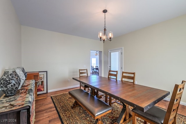 dining space featuring a chandelier and dark hardwood / wood-style floors