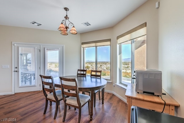 dining area featuring a chandelier and dark hardwood / wood-style floors