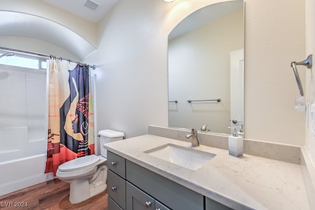 full bathroom featuring vanity, toilet, wood-type flooring, and shower / tub combo with curtain