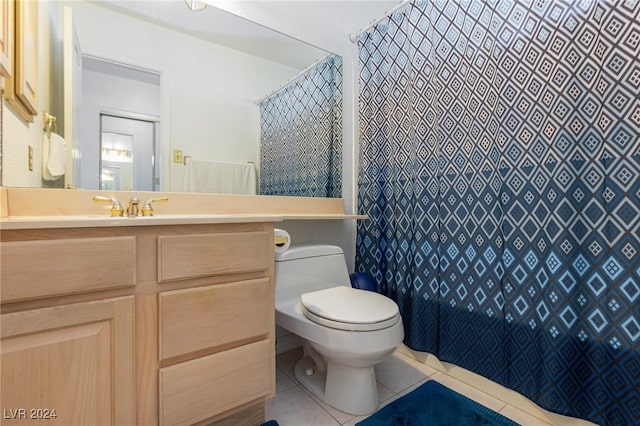 bathroom with vanity, toilet, and tile patterned floors