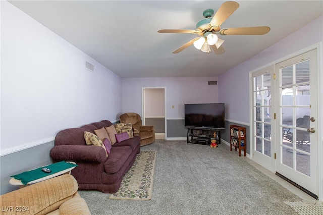 carpeted living room with ceiling fan