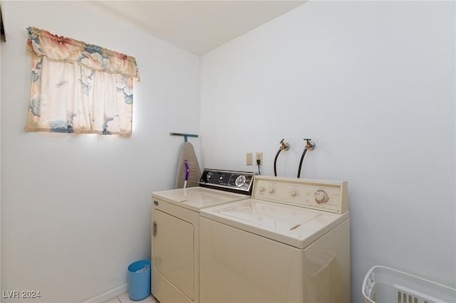 clothes washing area with separate washer and dryer