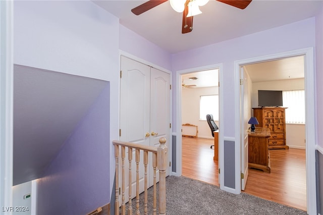 corridor featuring lofted ceiling and hardwood / wood-style floors