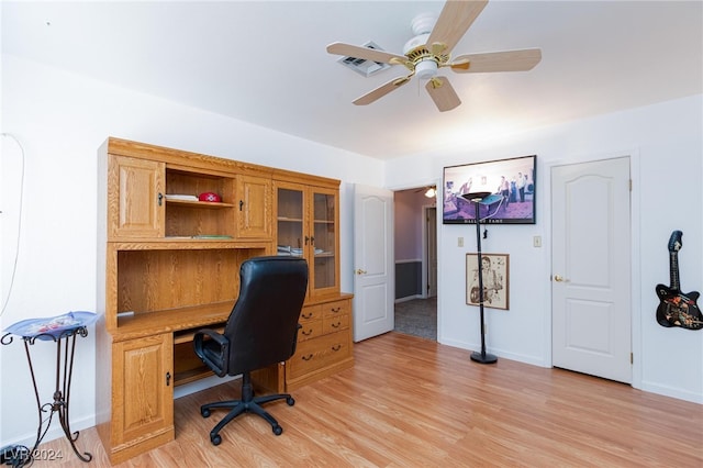 home office with light wood-type flooring and ceiling fan